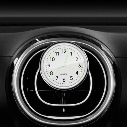 An Essential Luminous Clock for Everyday Car Drives mounted on car air vent with glowing dial for distraction-free nighttime time checks