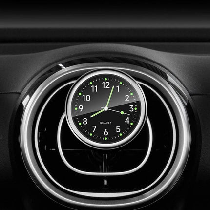 An Essential Luminous Clock for Everyday Car Drives mounted on dashboard air vent with glowing dial for safe night driving