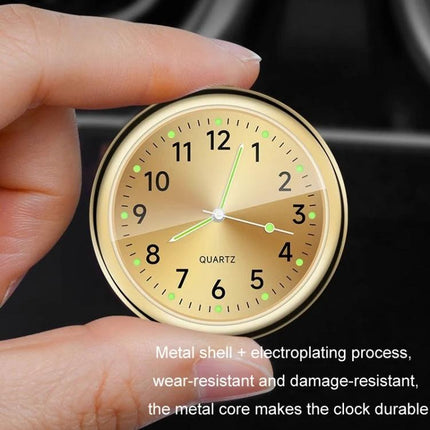 An Essential Luminous Clock for Everyday Car Drives - gold luminous dial car mount clock shown between fingers, easy-to-glance glow for night driving