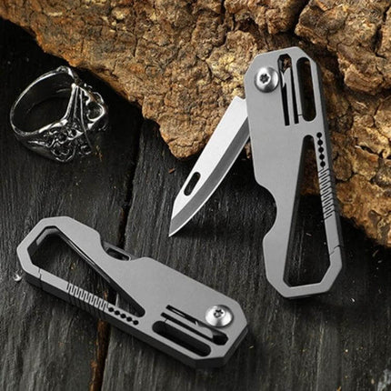 Titanium Keychain Folding Knife With Titanium Ring For Everyday Carry compact titanium keychain knife folded and open on wood background
