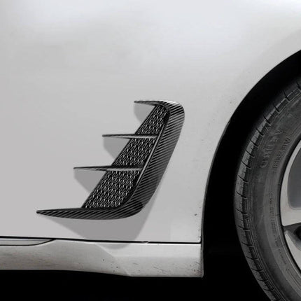 Universal Bright Black Carbon Fiber Car Fender Stickers applied on white car fender near wheel, TPU curved textured sporty accent