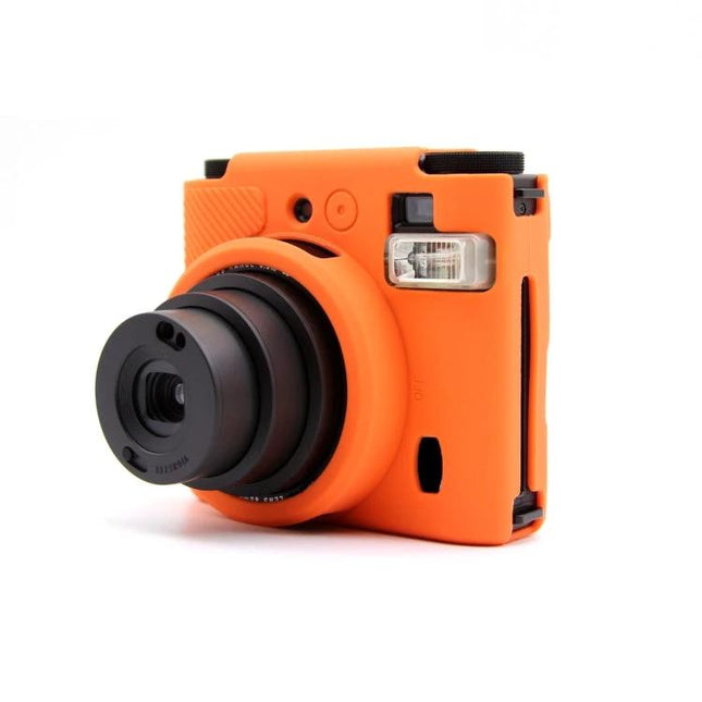 FUJIFILM Instax Mini 99 Silicone Protective Camera Case in bright orange fitted on instant camera, showing lens and flash access