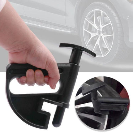 Handy Bead Clamp for DIY Tire Changes at Home - black plastic bead clamp held by hand for securing tire beads during garage tire removal