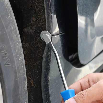 Essential Tool for Car Door Panel Removal in Home Repairs - metal pry tool removing interior clip near wheel well for DIY vehicle maintenance