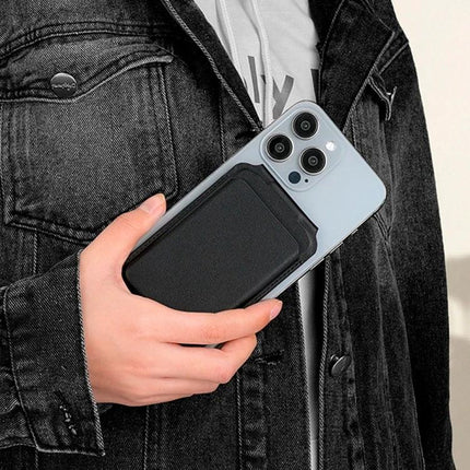 MagSafe Wallet Card Holder with Adjustable Stand for Phones attached to iPhone in hand, black PU leather wallet and kickstand