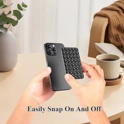Magnetic Silicone Phone Stand for Hands-Free Surface Mounting showing removable suction pad snapped onto a smartphone for mirror or dashboard use