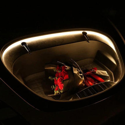 Tesla Front Trunk Welcome Light Bar For Model Three And Y illuminating frunk with warm 3000K glow while groceries and a bouquet sit inside