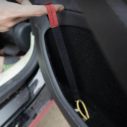 Door Emergency Pull Cord For Tesla Model Three And Y installed inside door pocket showing red nylon pull strap for manual exit