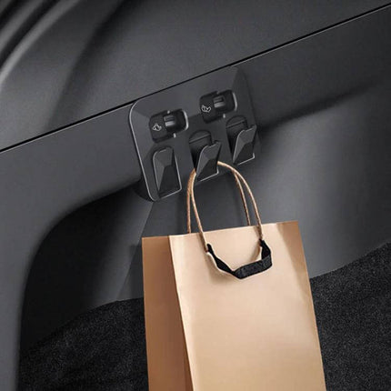 Hidden Trunk Hook for Tesla Model Y Foldable Car Organizer installed in trunk holding a shopping bag, snap-in foldable ABS hook