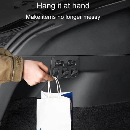 Hidden Trunk Hook for Tesla Model Y Foldable Car Organizer installed in trunk holding shopping bag, snap-in hidden foldable hook for tidy cargo