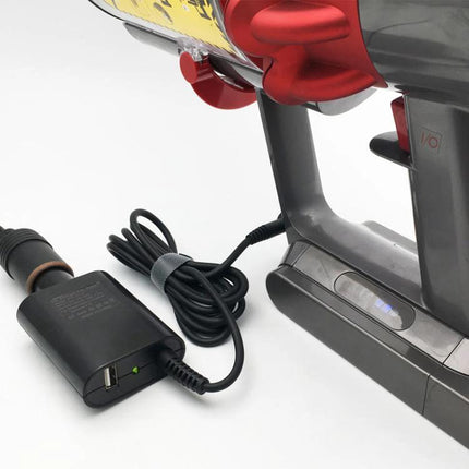 Portable Car Charger for Dyson V10 and V11 Vacuum Cleaners connected to a Dyson handheld vacuum in a car-ready setup