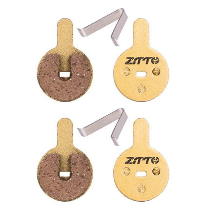 ZTTO Mountain Bike Brake Pads Full Metal Copper Base shown as four circular copper-backed pads with friction material and retention springs, low-noise durable design