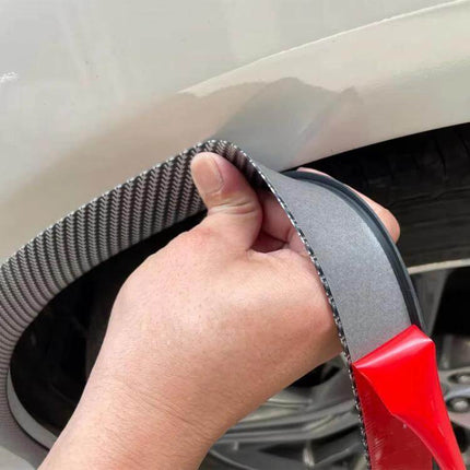 Self-Adhesive Protective Trim for Car Wheel Arches and Door Edges being applied to wheel arch to protect against scrapes and minor impacts