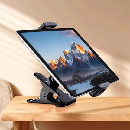 Adjustable Desktop Clamp Holder for Phones and Tablets securely holding a tablet on a wooden desk, metal and plastic clamp for video, meetings, recipes
