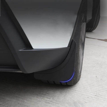 Splash Guards for Tesla Model Y Juniper, Protecting from Mud and Splashes — close-up of rear mud flap on white Tesla with blue accent protecting tire and body