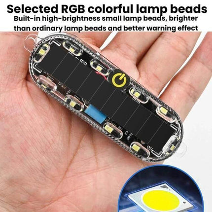 Car Solar-Powered Anti-Collision Warning Light 2-Pack showing one compact RGB LED solar warning light held in a hand, highlighting solar panel and LED beads