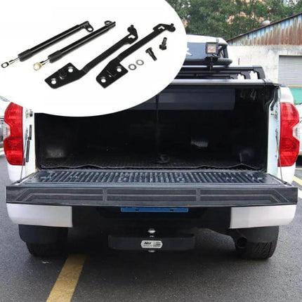 Tailgate Hydraulic Lowering Lever for Mitsubishi Triton 2015-2022 installed on open Triton tailgate, showing hydraulic struts and mounting brackets