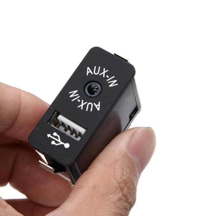 BMW AUX USB Input Socket Switch For Central Console Replacement - black ABS USB and AUX-IN panel held in hand