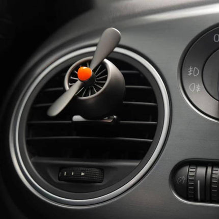 Bbdd Zinc Alloy Car Air Vent Air Freshener Ornament clipped to circular car vent with propeller design and orange center, compact zinc alloy fragrance clip
