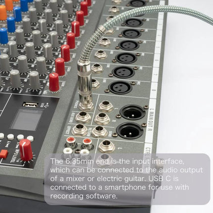Cable for Connecting Guitar to Phone for Recording Sessions plugged into mixer input and Type-C end ready for mobile recording
