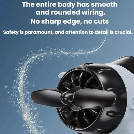 Solar-Powered Car Dashboard Airplane Ornament That Rotates in Sunlight close-up of black propeller and smooth rounded body on blue background