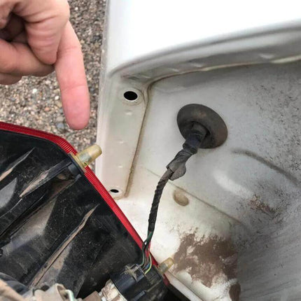 Car Taillight Mounting Clip For Mitsubishi Pajero Direct Replacement shown installed on a Pajero tail assembly with wiring harness