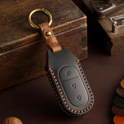 Hallmo Genuine Leather Car Key Cover for Leapmotor Keys in black cowhide with brown stitching and brass keyring, protects buttons and resists scratches