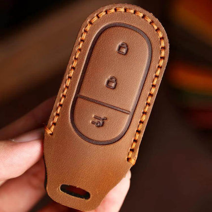 Hallmo Genuine Leather Car Key Cover for Leapmotor Keys shown in brown cowhide with stitched edges protecting key buttons