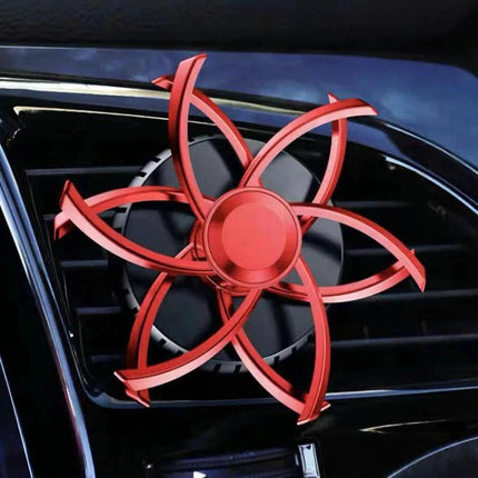 Car Air Vent Ornament Rotating Snowflake With Fragrance Pad installed on car vent, red rotating snowflake design adding subtle scent and motion