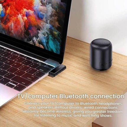 Car Audio Aux Bluetooth Transmitter Receiver Dual Function compact Bluetooth 5.1 USB dongle next to laptop for wireless audio and TF card playback