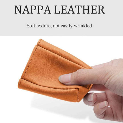 Leather Car Seat Belt Buckle Protector for Everyday Use showing hand holding nappa leather orange cover with soft, wrinkle‑resistant texture