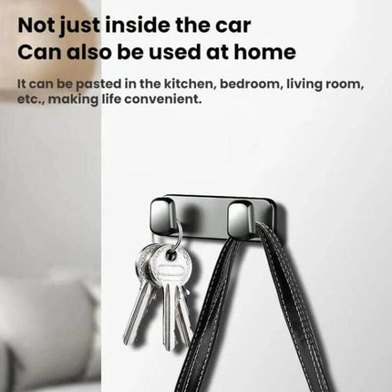 Car Front Seat Zinc Alloy Adhesive Hook For Cables And Bags showing keys and a bag hung on a silver zinc alloy adhesive hook mounted on a wall