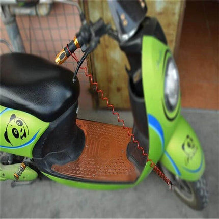 Motorcycle Disc Lock Reminder Cable For Theft Protection attached between disc lock and handgrip on green scooter