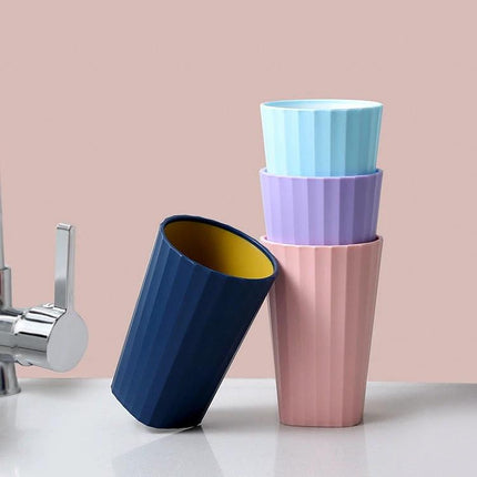 Bathroom Cup for Daily Toothbrushing with Handle - stack of colorful ribbed plastic cups with handle for rinsing and toothbrush drainage