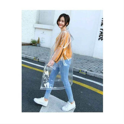 Transparent EVA Raincoat for Everyday Outdoor Protection — clear waterproof EVA raincoat worn over casual outfit during commute