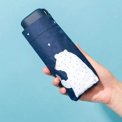 Compact Anti-UV Folding Umbrella for Everyday Outdoor Use — navy triple-fold umbrella with white bear print in hand