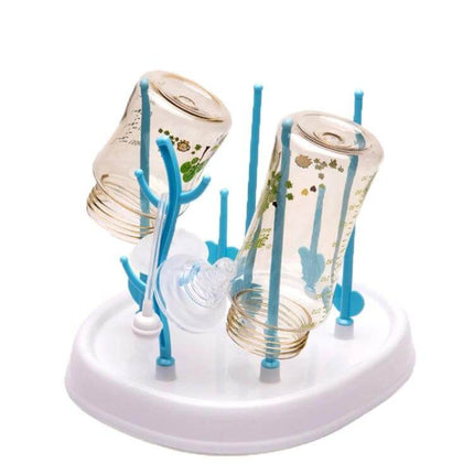 Baby Bottle Drying Rack Tree Shape For Infant Bottles on white countertop holding two inverted glass bottles and nipples