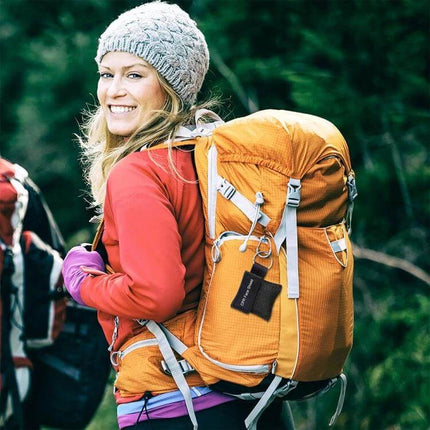 Compact CPR Face Shield Mask with Key Ring for Emergencies attached to orange hiking backpack for quick access during outdoor trips