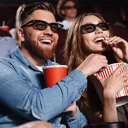 Fasdga Polarized 3D Glasses for Cinema Movie Viewing - couple wearing polarized 3D glasses enjoying movie with popcorn and drink