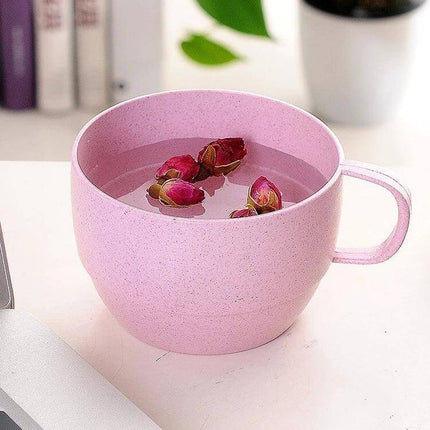Wheat Straw Coffee Cup 201-300ml For Home Office Use - Pink wheat straw cup with handle holding floral tea on desk
