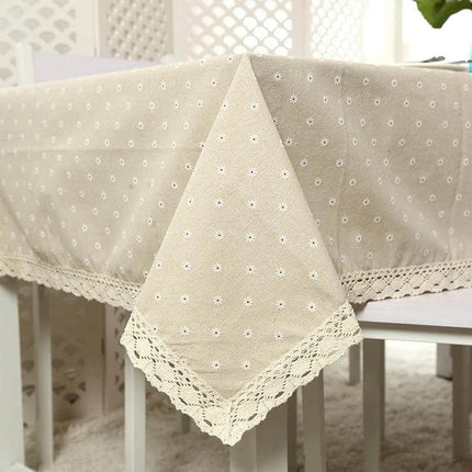 Lace Tablecloth For Dining And Events In Linen Blend draped over dining table with delicate lace trim and subtle dotted texture