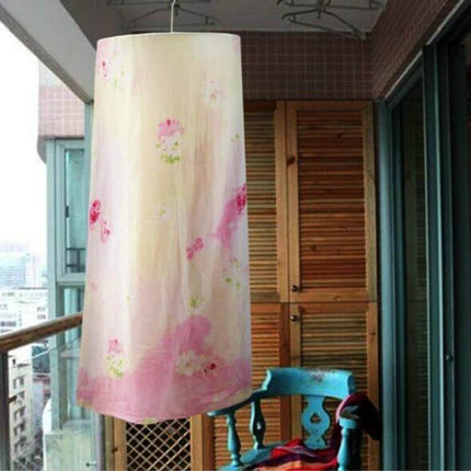 Round Balcony Spiral Drying Rack, 2.2m For Sheets And Duvet Covers hanging on a balcony with wrought iron frame and wooden connectors