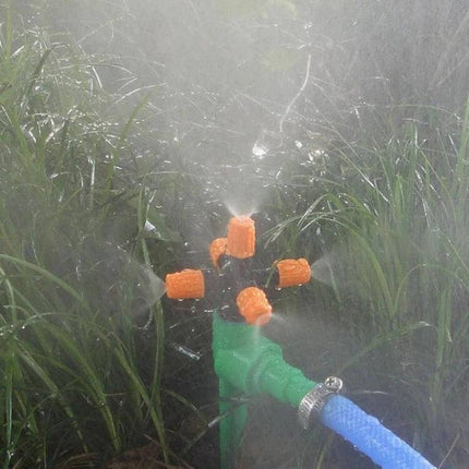 Cross Five-Outlet Spray Nozzle 2-Pack for Garden Watering shown spraying even mist over lawn and plant beds