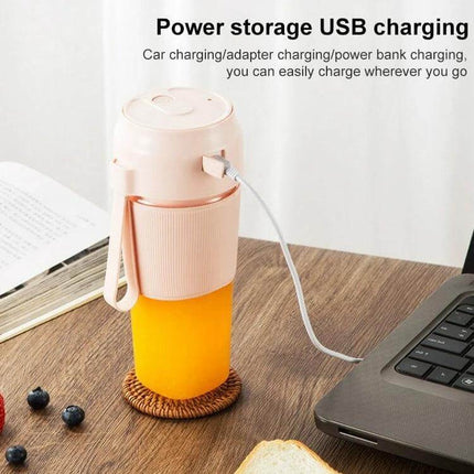 Portable Juicer Mini Electric Blender Pink For Smoothies On The Go - compact 300mL cordless USB rechargeable blender shown charging next to laptop