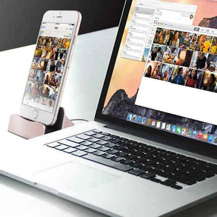 Desk Stand for Easy Smartphone Charging and Viewing showing smartphone charging on a desk next to a laptop