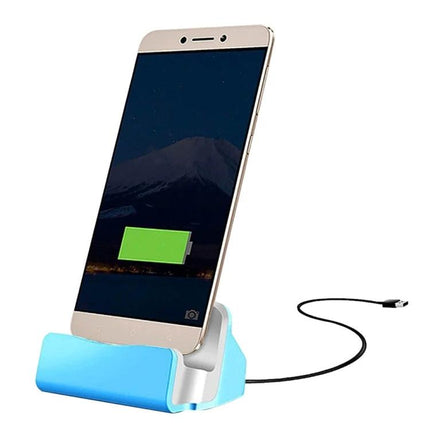 Desk Stand for Easy Smartphone Charging and Viewing showing phone upright in blue charging dock with USB cable connected