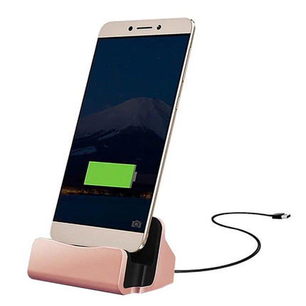 Desk Stand for Easy Smartphone Charging and Viewing showing rose gold cradle with phone charging via USB cable, hands-free screen access