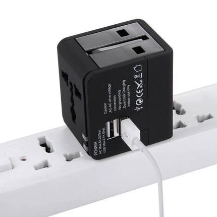 Compact Universal Dual USB Charger Adapter for Travel and Home Use plugged into power strip with USB cable connected