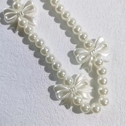 Versatile Handmade Butterfly Pearl Resin Phone Chain Accessory showing white pearl beads and butterfly resin bows for phone or bag