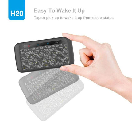 H20 Wireless Touchpad Keyboard for Everyday Computing Tasks showing compact QWERTY and integrated touchpad being picked up